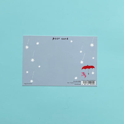 The writing area of a post card, that's light blue with white stars and a red umbrella.