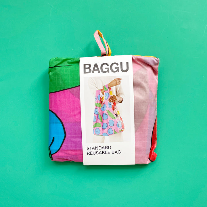 Standard Apples and Bananas reusable bag on green background.