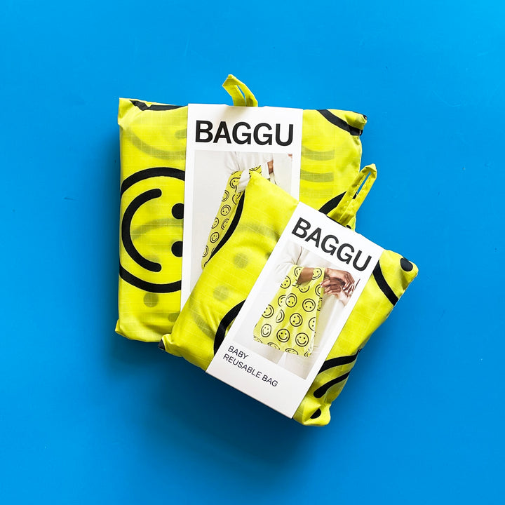 Standard and baby Happy Face bags on blue background.