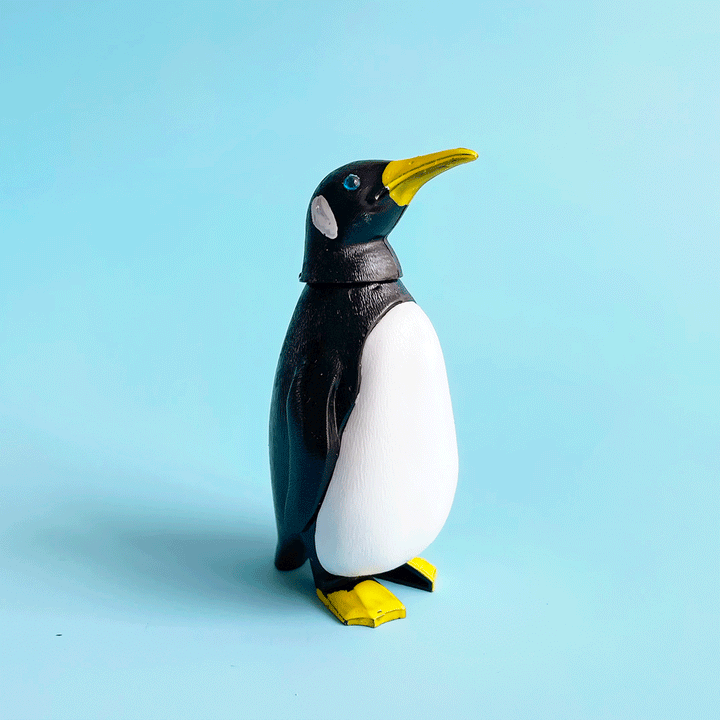 A gif of a plastic penguin bobblehead bobbing it's head.