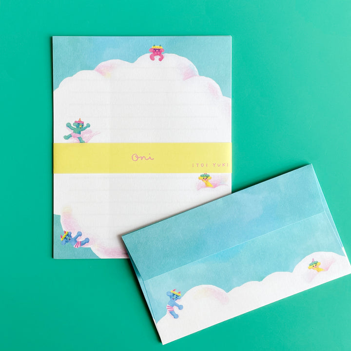 An in the clouds letter set illustrated with blue sky, a big pink cloud and colorful figures.
