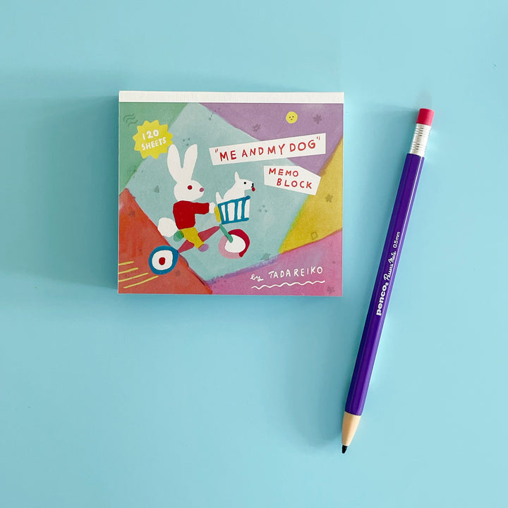 A small memo book and purple mechanical pencil