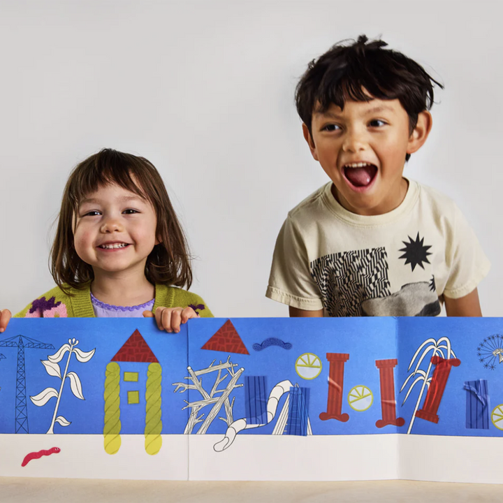 Two children excitedly sharing a sticker collage they made with the Majo Ideas Home Activity Kit.