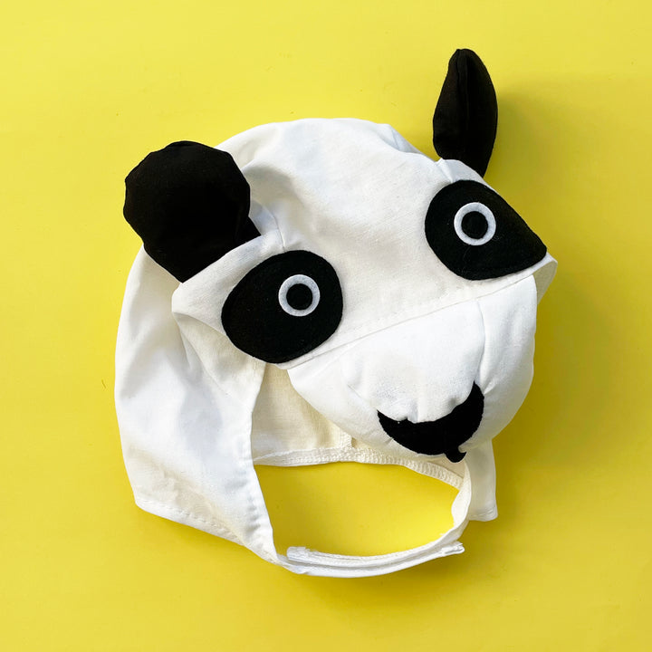 White cotton panda cotrume hat with black felt accents and stuffed ears. Displayed on a bright yellow background.