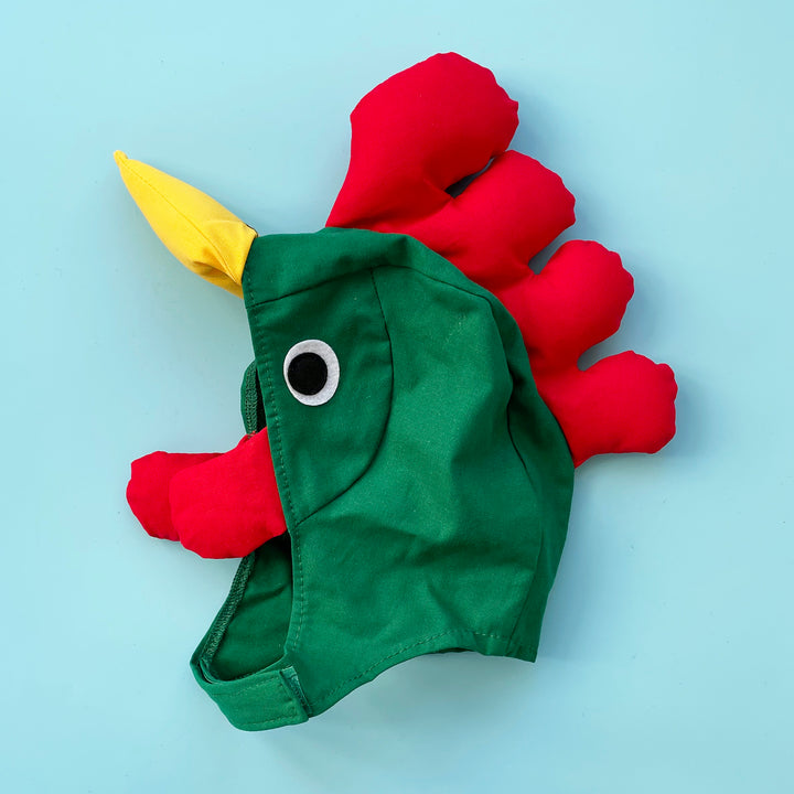 Green cotton rooster costume hat with padded yellow eak, red padded crest and felt eyes. Displayed on a light blue background.