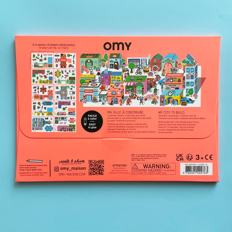 The back of the 3d paper city kit package shows the 10 sheets of pre-cut parts you can assemble into your city with the kit, including a hospital, a depot, and and many characters and vehicles.