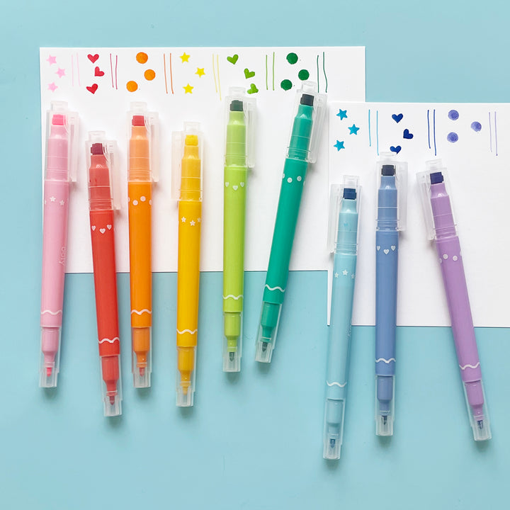 Nine double sided Confetti Markers from Ooly displayed on a white paper highlighting the shapes that each marker makes.