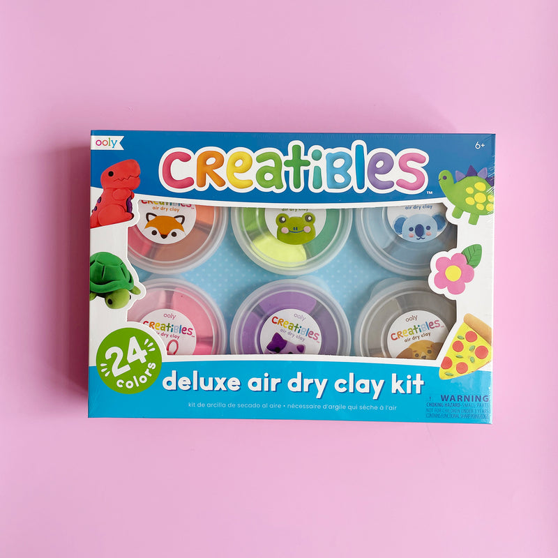 The Creatibles Deluxe Air Dry Clay Kit sits on a pink background.