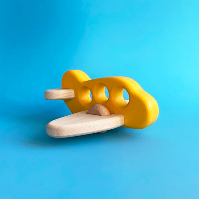 A simple wooden toy airplane, with a yellow painted body and unpainted wooden wings.