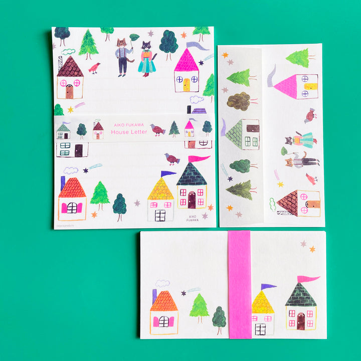 An stationary set illustrated with bright houses on a bright green background.