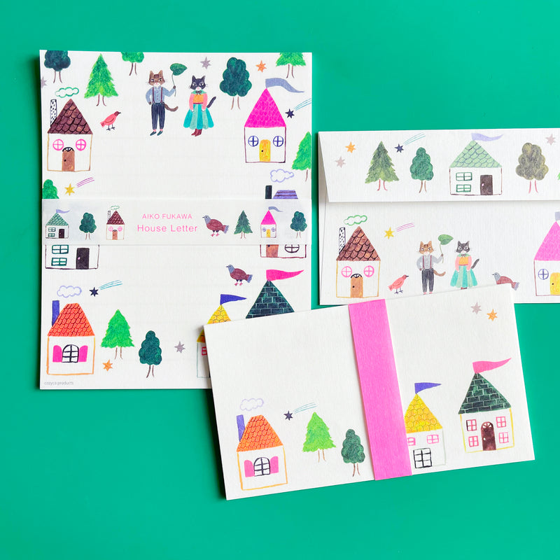 An stationary set illustrated with bright houses on a bright green background.