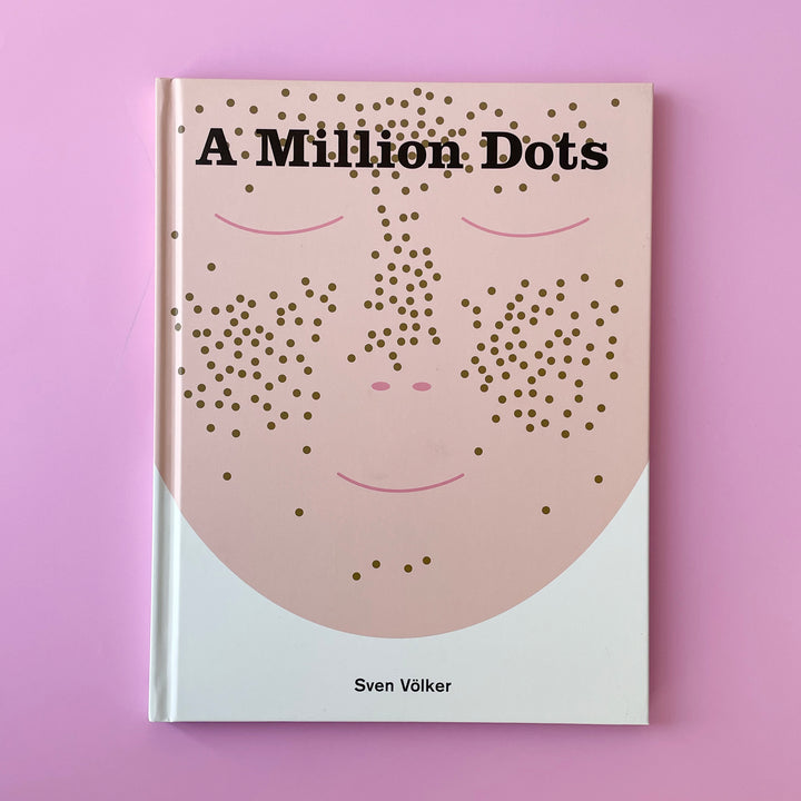 A copy of the book "A Million Dots". The cover features an illustration of peach colored face with brown freckles.