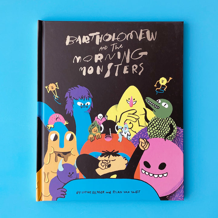 A copy of the book Bartholomew and the Morning Monsters. The cover features a colorful illustration of a boy waking up surrounded by monsters.