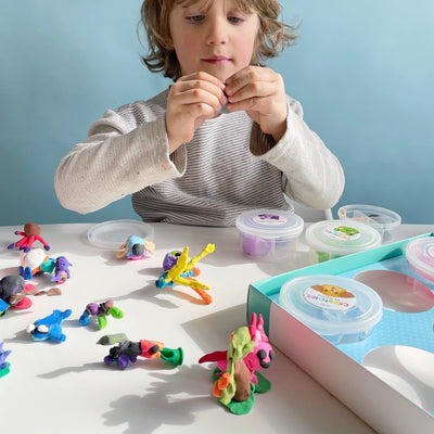 A child makes various sculptures out of multi-colored clay.