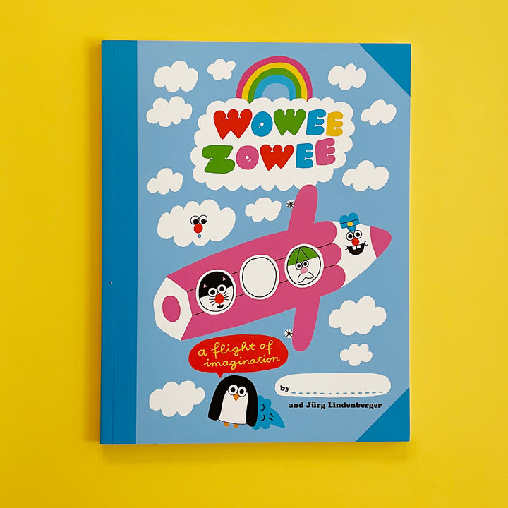 A copy of the book "Wowee Zowee". The cover features a playful and colorful  illustration of a pencil-plane in a blue sky with white clouds and a rainbow.