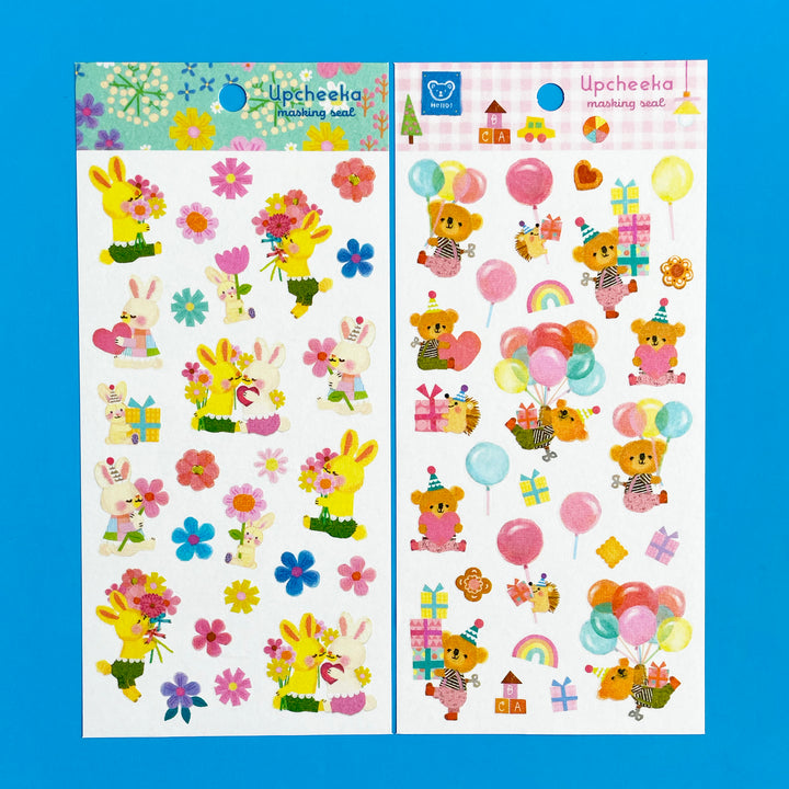 Two sheets of cartoon style stickers displayed against a blue background. The sticker sheets feature bunnies and bears with traditional birthday accessories like presents and balloons. 