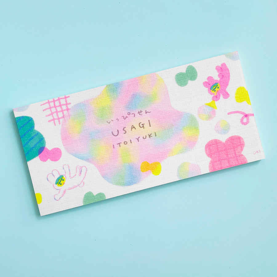 Colorful memo pad with playful drawings in pastel colors on a light blue background