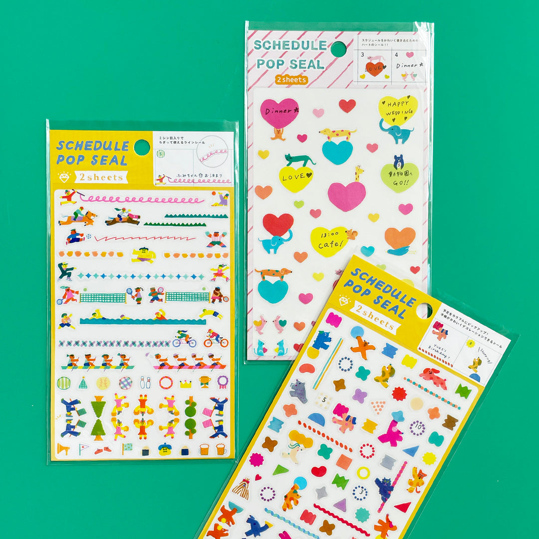 Three sheets of colorful stickers with various designs on a green background