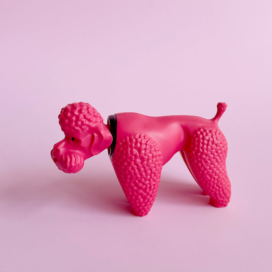 Bright pink poodle shaped bobblehead figurine 