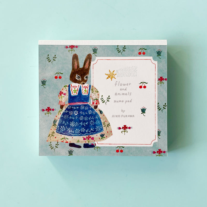 The flower and animals memo pad by Aiko Fukawa on a blue background.