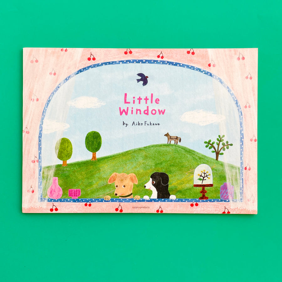 A "little window" notepad. The notepad features a sweet illustration of a window looking out onto a green hill. Two dogs look in the window.