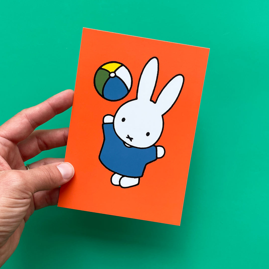 Miffy and beach ball postcard on green background