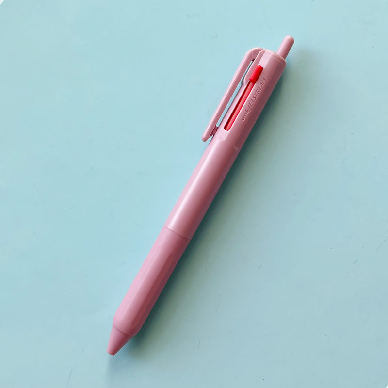 a lilac colored 3 Color Pen on a blue background