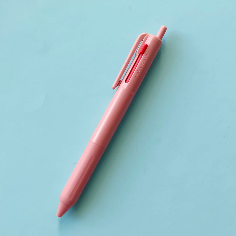 a light pink 3 Color Pen on a blue background