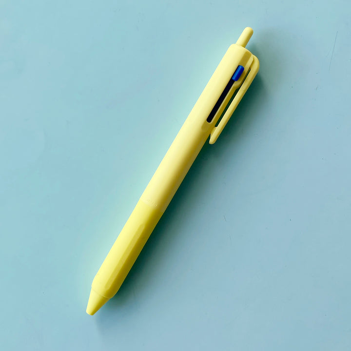 a yellow 3 Color Pen on a blue background