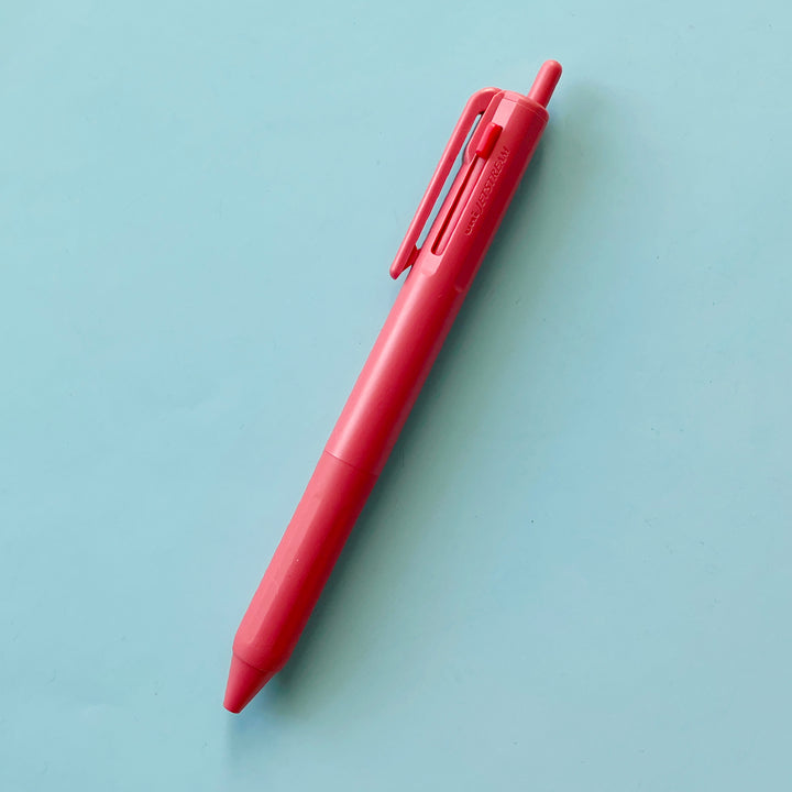 a dark pink 3 Color Pen on a blue background