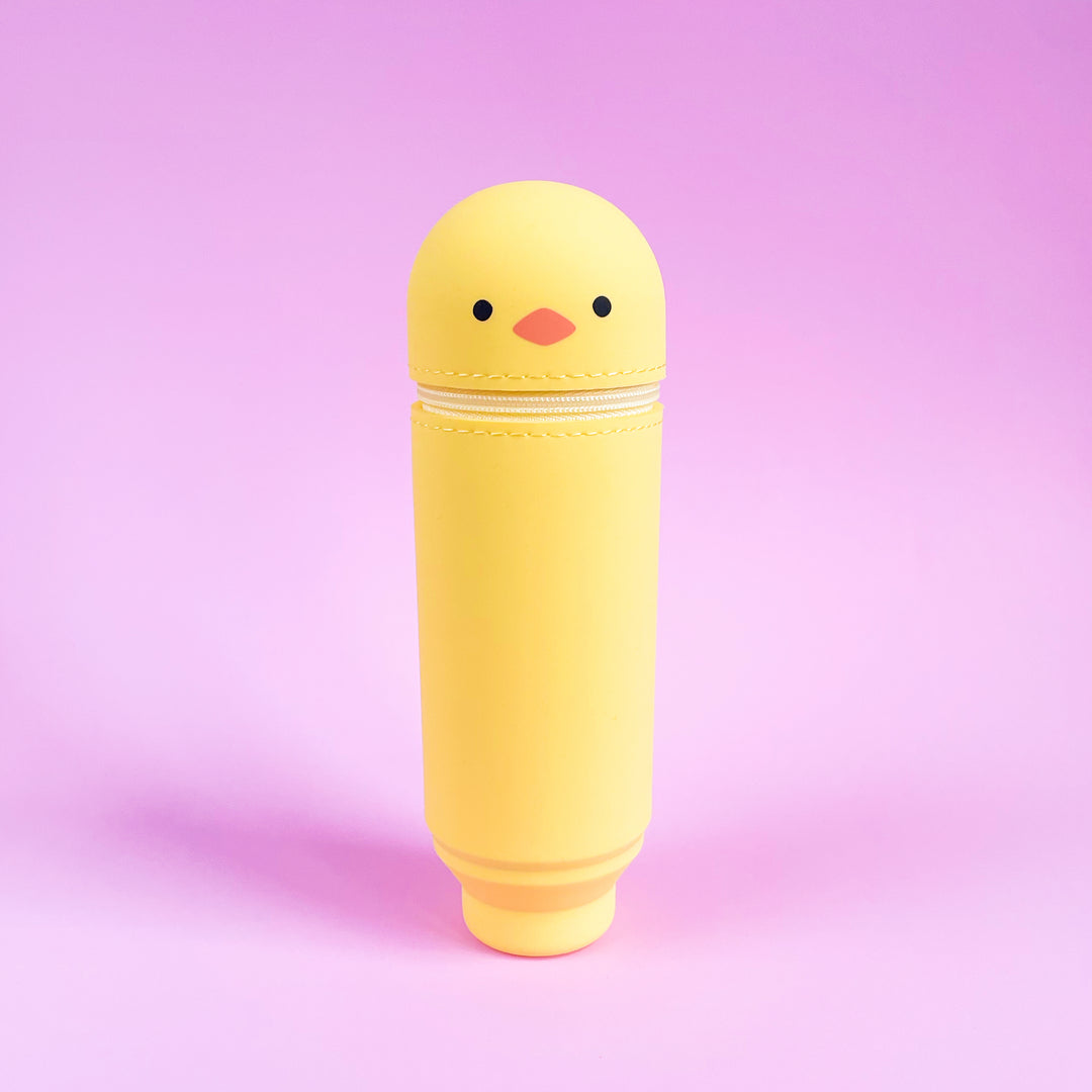 Yellow chick-shaped container on a pink background