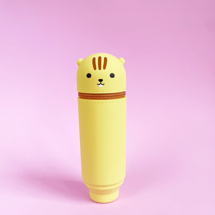 Yellow chimpunk-shaped pen case on a pink background