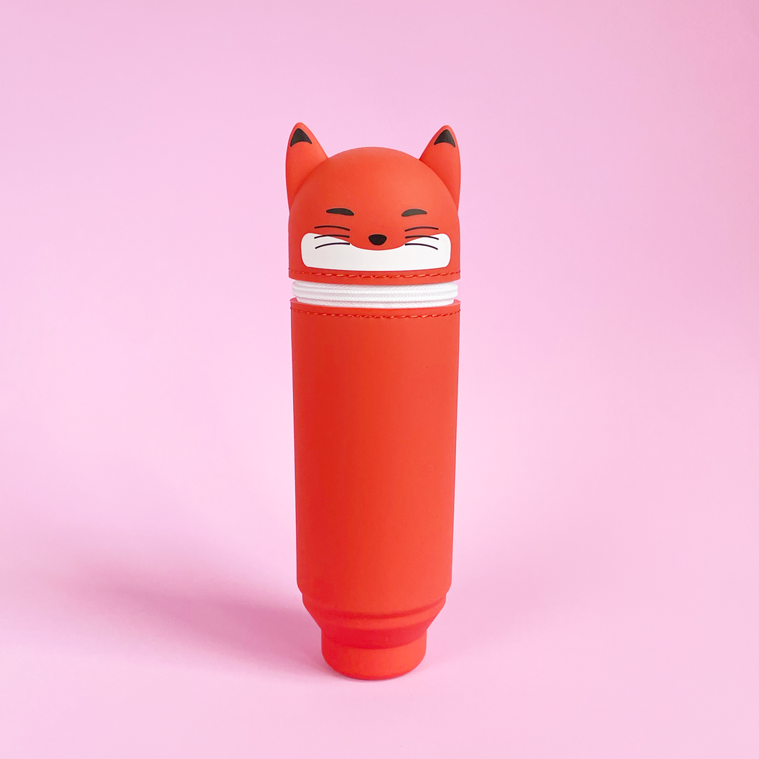 Red fox-shaped pen case on a pink background