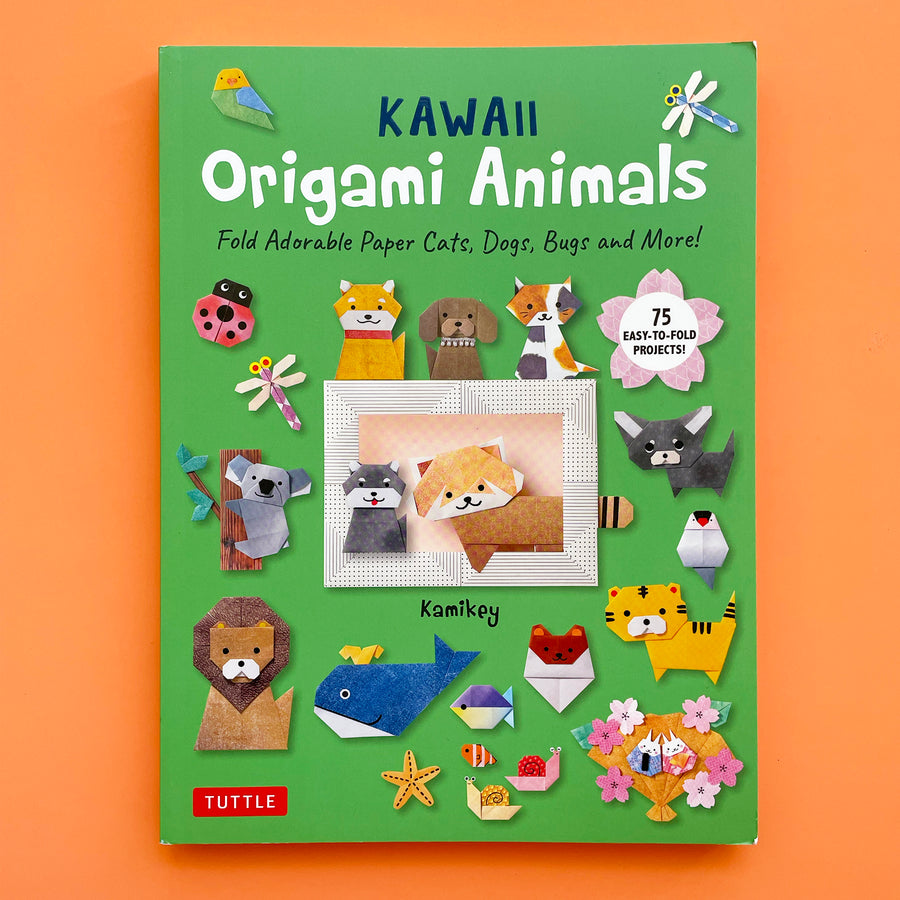 Kawaii Origami Animals book displayed on a bright orange background. The book cover features origami projects including a  koala, a red panda, cats, dogs and bugs. 