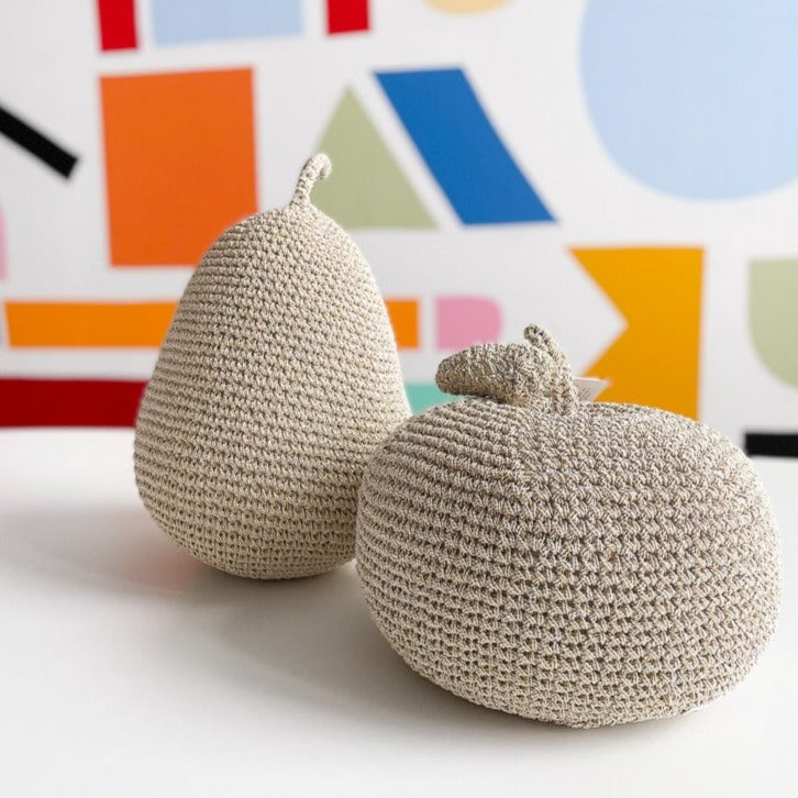 Crocheted pear and apple on a colorful background. 