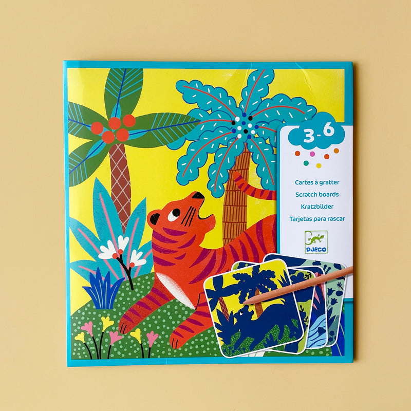 A scratch board kit illustrated with a colorful tiger and trees, on a light yellow background. 