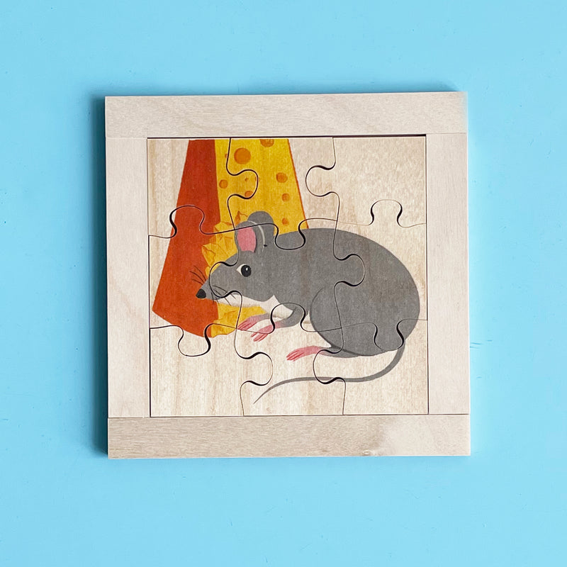 The 9-piece wooden puzzle is put together to show a mouse with a large piece of holey cheese.