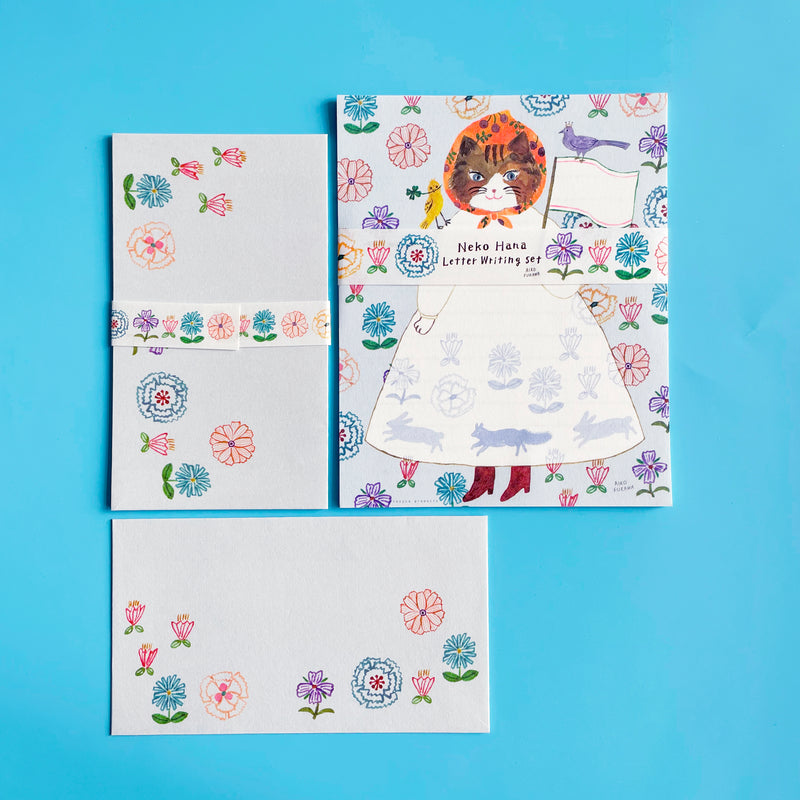 A stationary set illustrated with a cat and flowers. 
