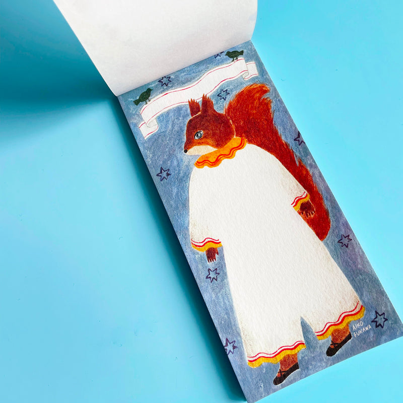 The memo pad is opened to a page featuring a anthropomorphic squirrel standing in a white jumpsuit on a blue starry background. A blank banner is at the top of the page.