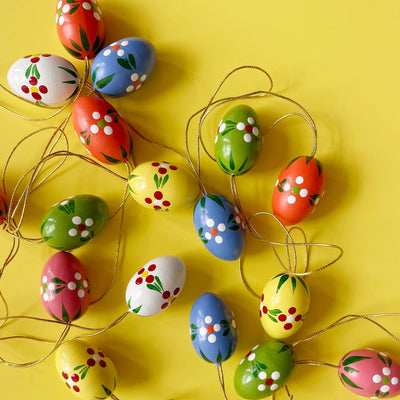 Several colorful shaped ornaments  on a yellow background. 